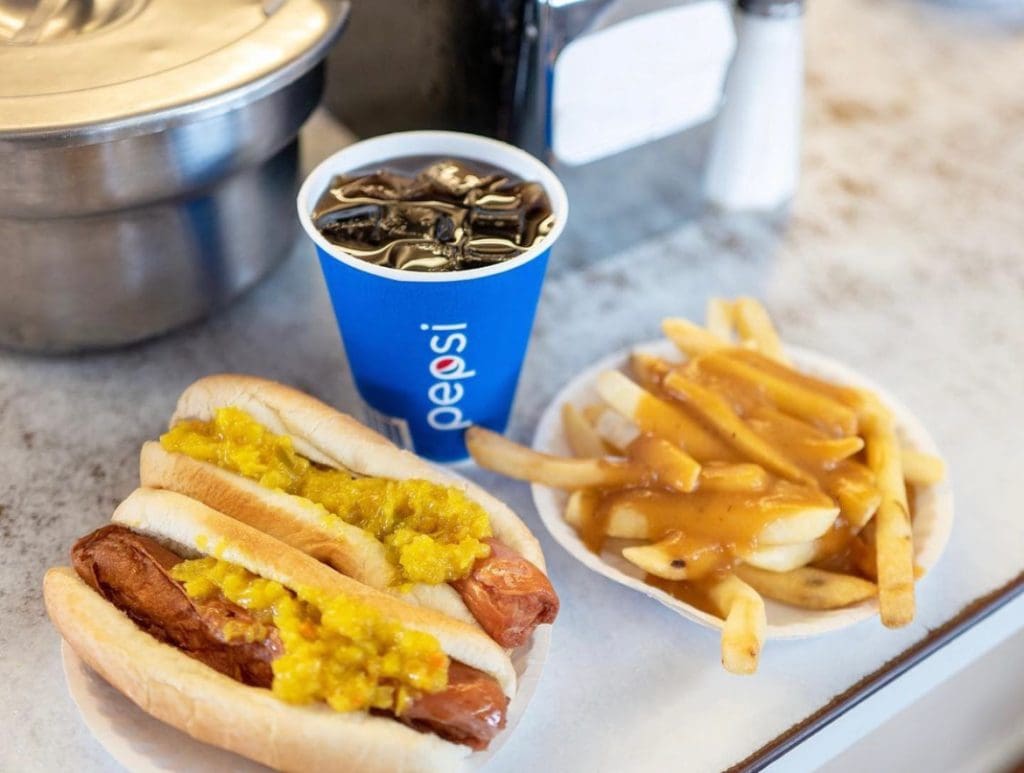 Two hot dogs and relish, fries and Pepsi.