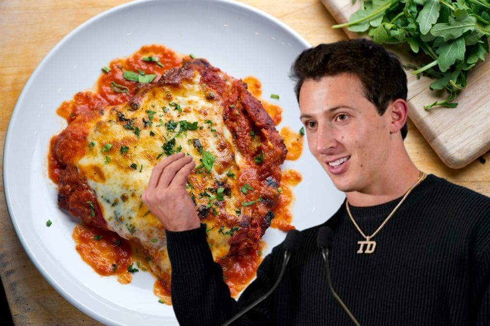 Tommy DeVito in front of a chicken parm