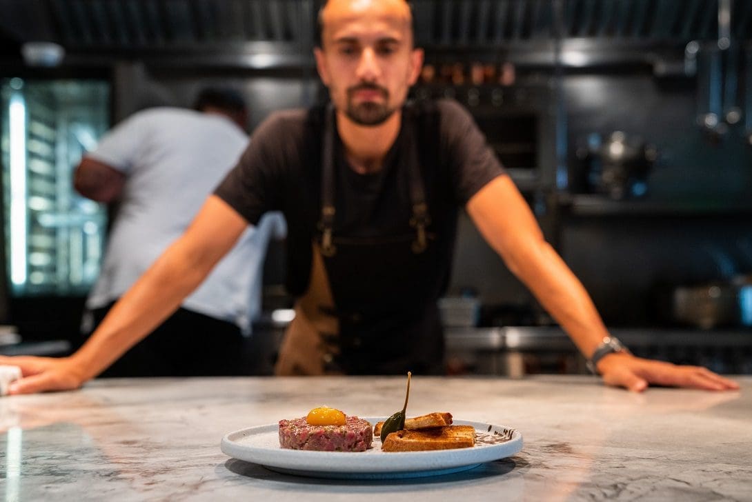 Chef Antonio De Ieso of Fiorentini in Rutherford, NJ admires a plated beef tartare