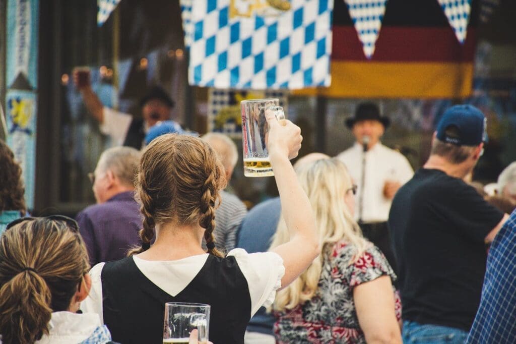 woman standing in crowd holding beer glass