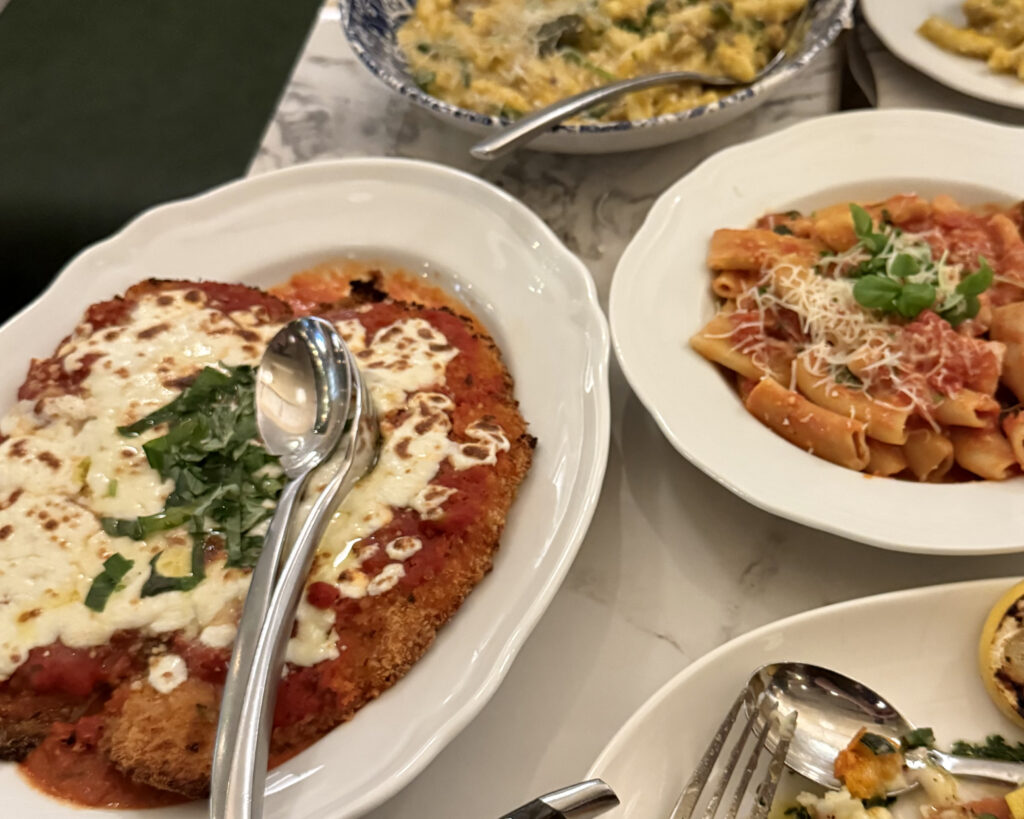 huge portion of crispy chicken parm with a side of rigatoni pasta