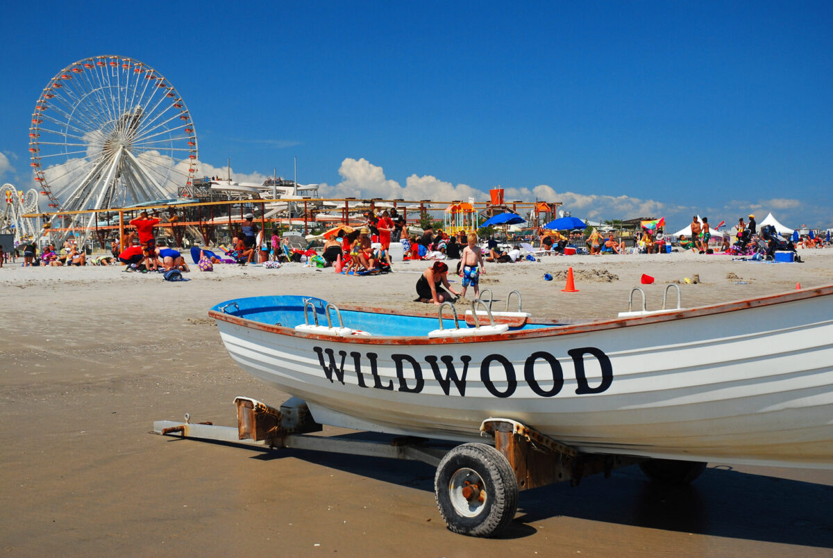 The beach at Wildwood, New Jersey with the boardwalk and Ferris wheel in the background