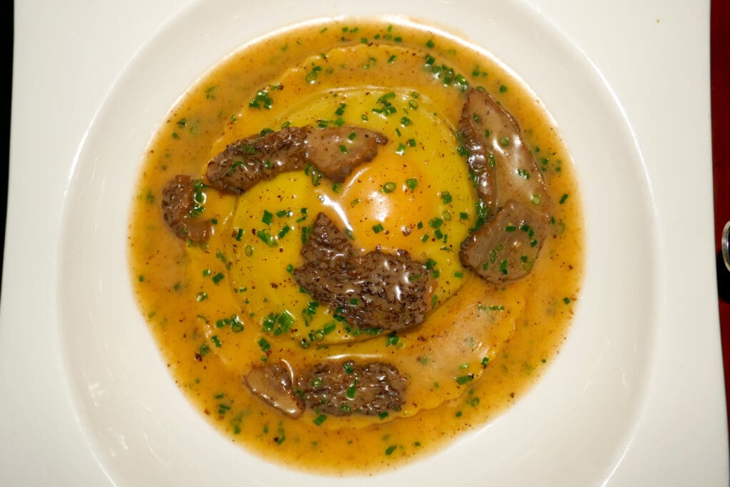 The egg yolk-stuffed raviolo, sauced with morels and butter