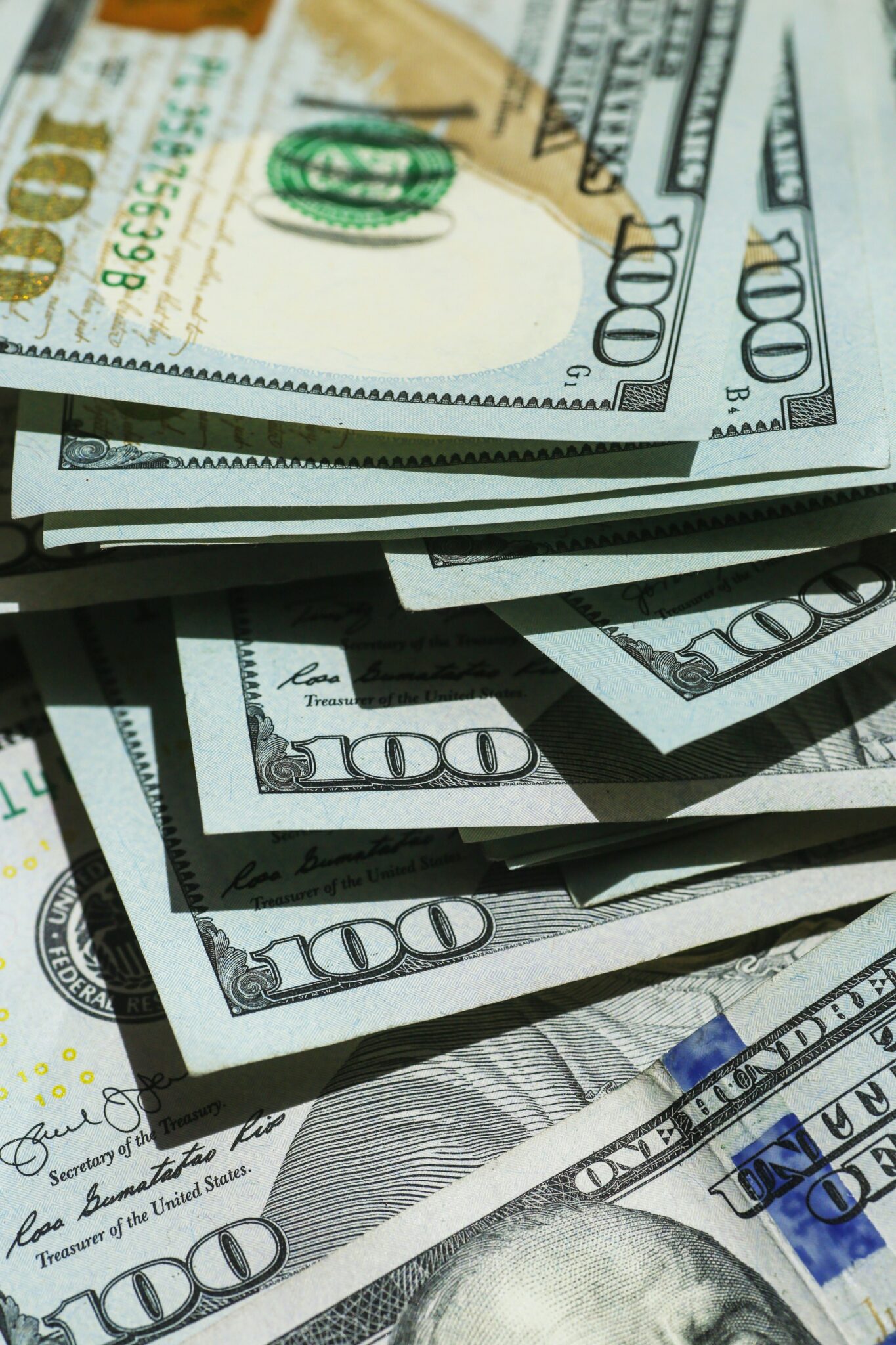 pile of 100 dollar bills