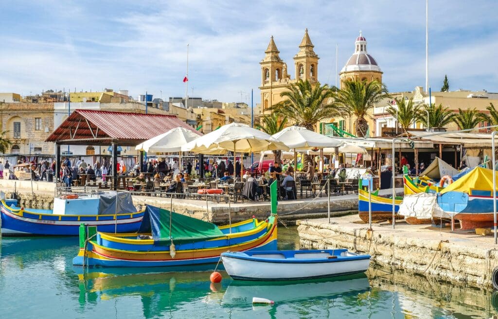On the water in Marsaxlokk, Malta with boats docked