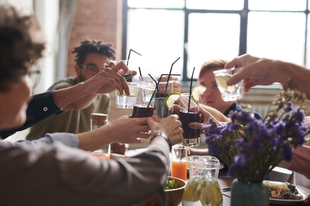 A group of people bringing their glasses together