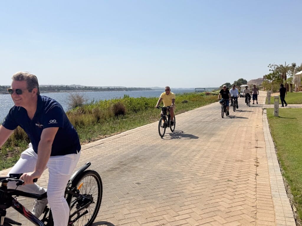 E-bike rider on Nile cruise path near Karnak Temple, Boat Bike Tours Egypt 2026