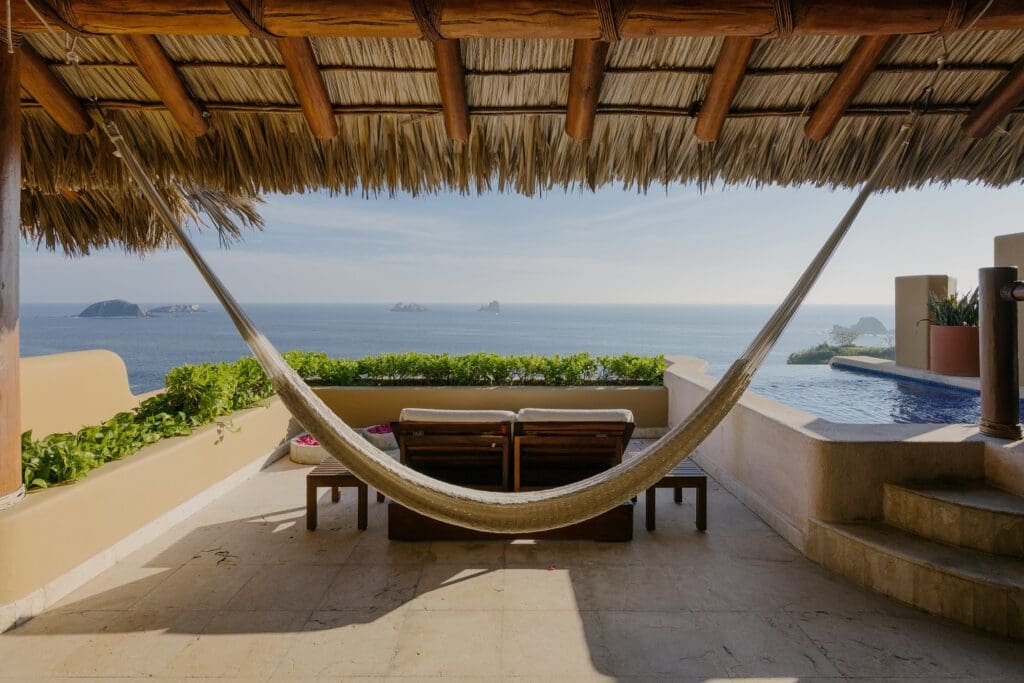 View of Cala de Mar Resort & Spa Ixtapa overlooking the Pacific Ocean at sunset.