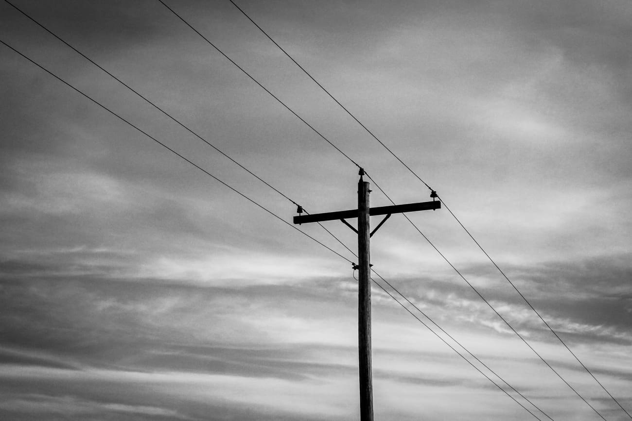 Electric utility pole under cloudy sky