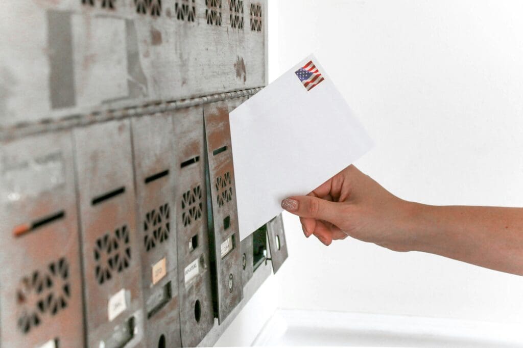 Voter dropping off mail-in ballots in New Jersey ahead of the 2025 gubernatorial election