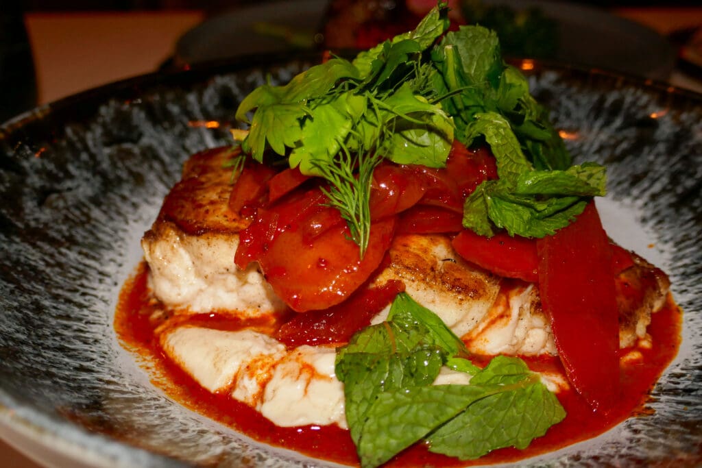 Seared halibut comes paired with carrot escabeche and aji blanco