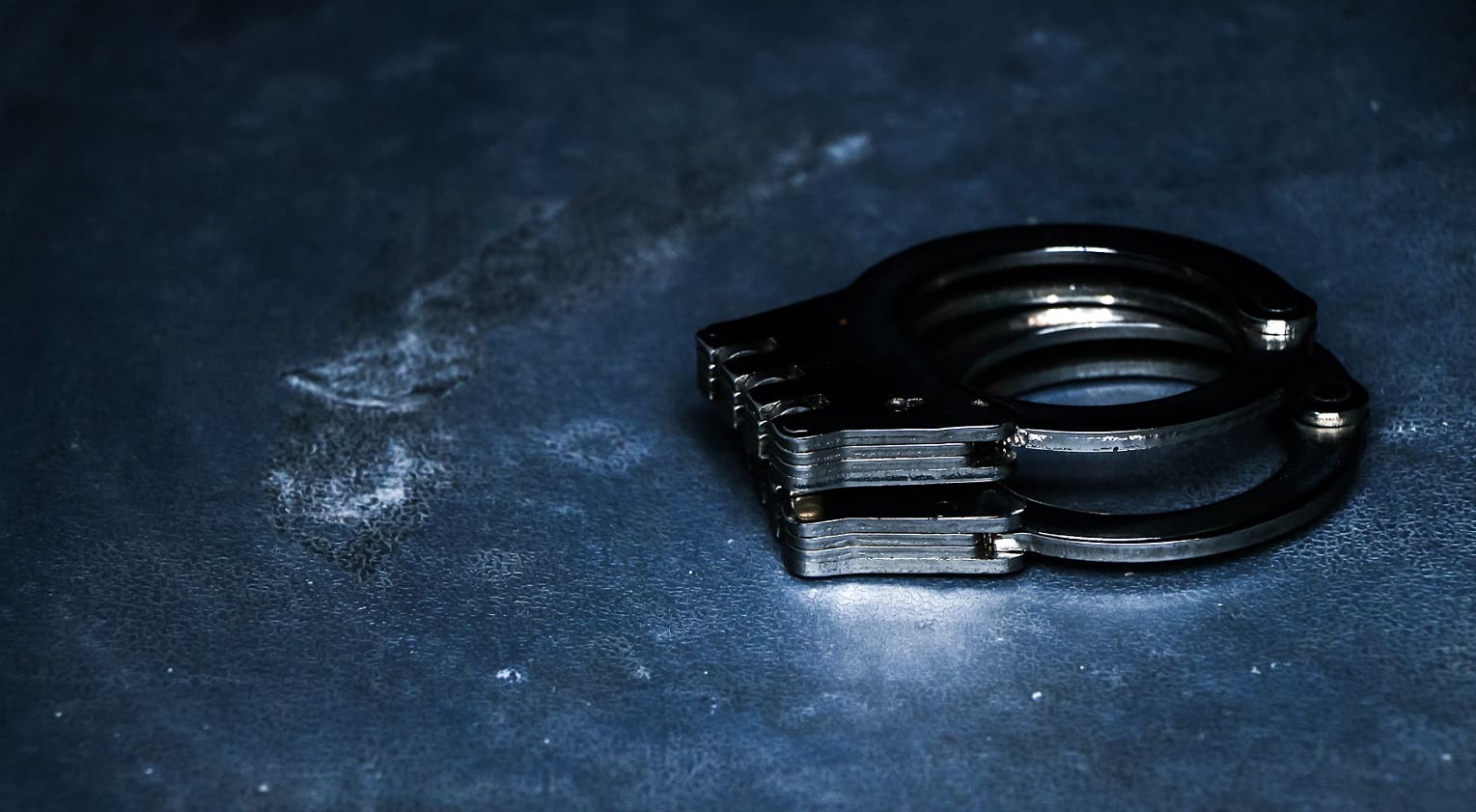 Handcuffs symbolize NJ college athletes charged in illegal betting ring