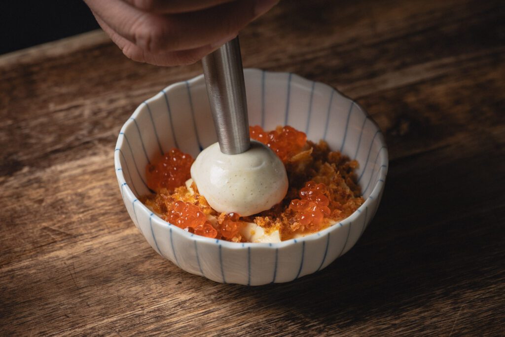 a dish being plated at Ram & Rooster, Best Restaurants in New Jersey 2025