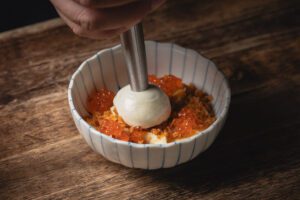 a dish being plated at Ram & Rooster, Best Restaurants in New Jersey 2025