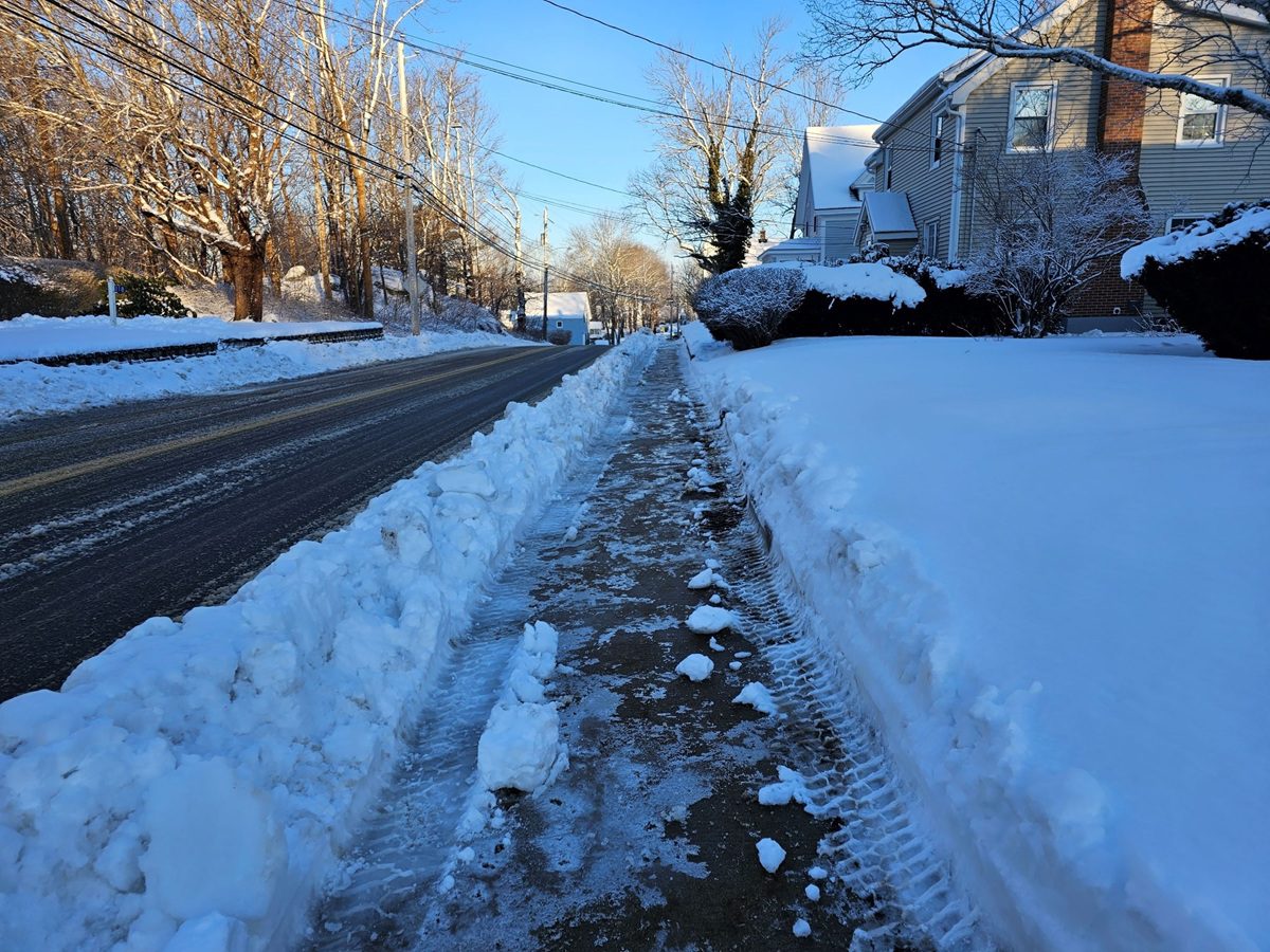 Snowbanks line a quiet New Jersey street after a recent storm.