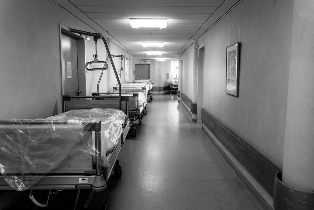 a black and white hospital hallway, underscoring first pediatric flu death amid rising influenza cases in nj