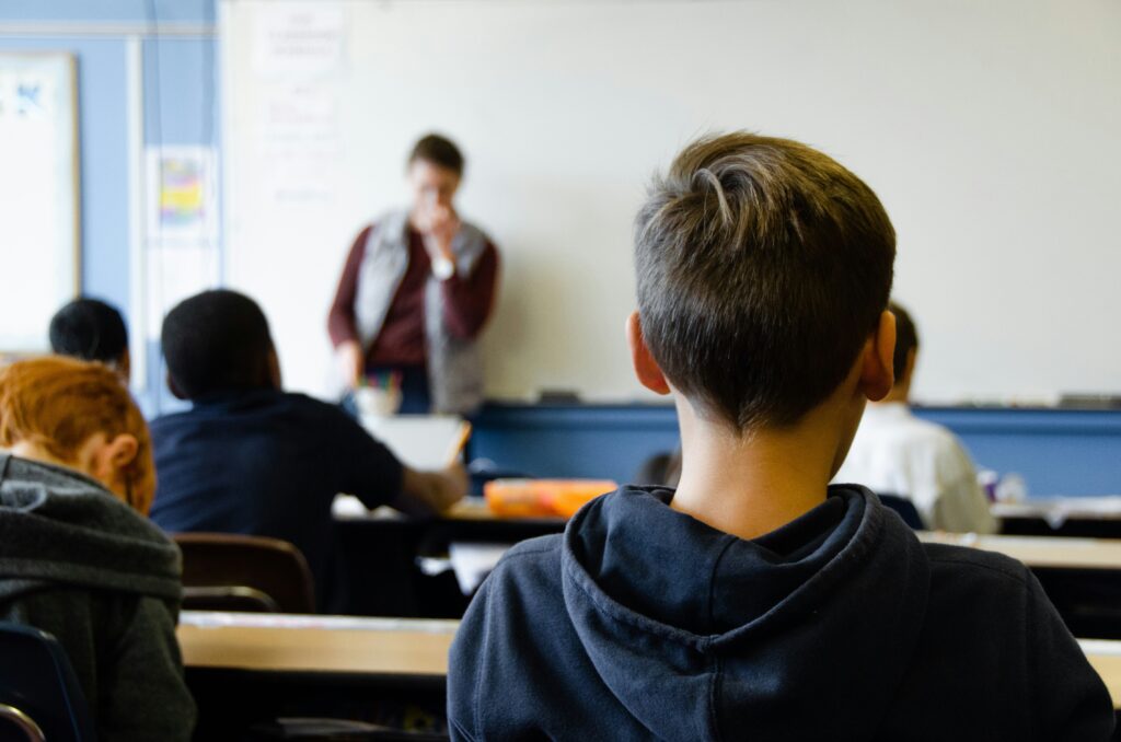 Students in a New Jersey classroom with cellphones stored, following the new “bell to bell” ban law