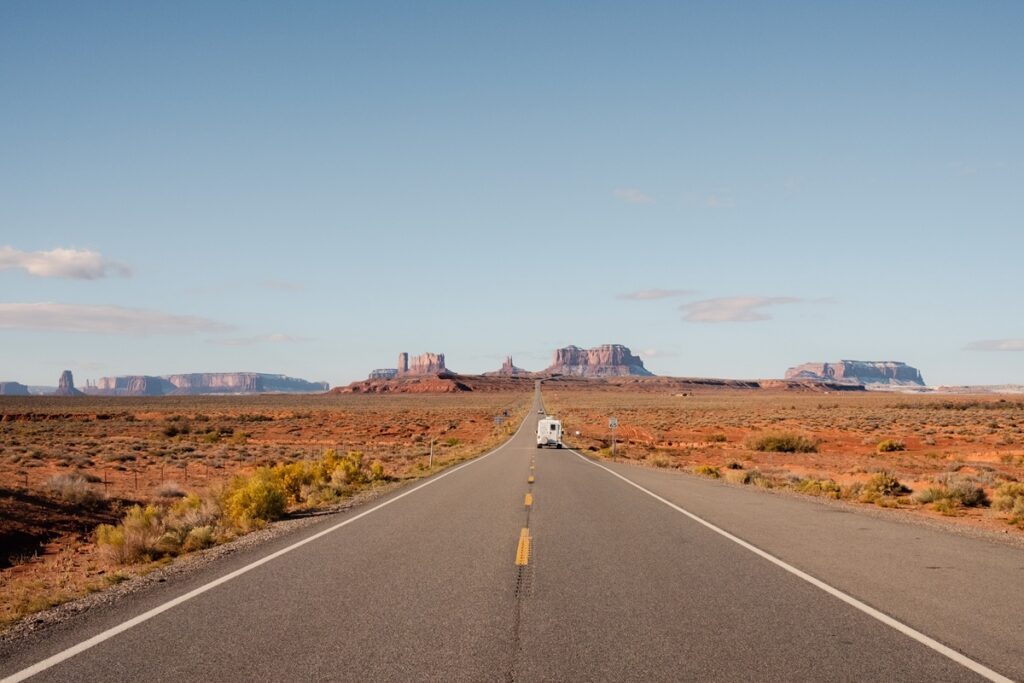 RV traveling along a desert highway in the American Southwest, representing affordable U.S. travel destinations for 2026