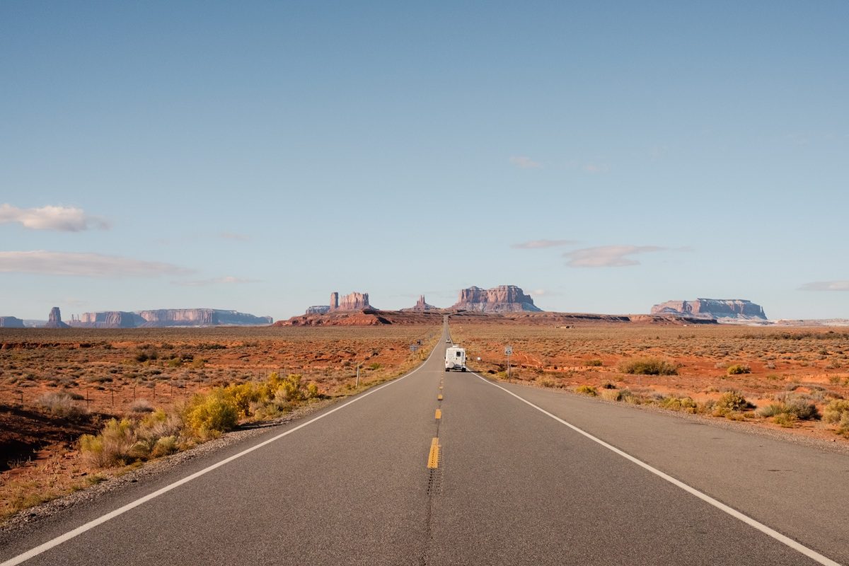 RV traveling along a desert highway in the American Southwest, representing affordable U.S. travel destinations for 2026