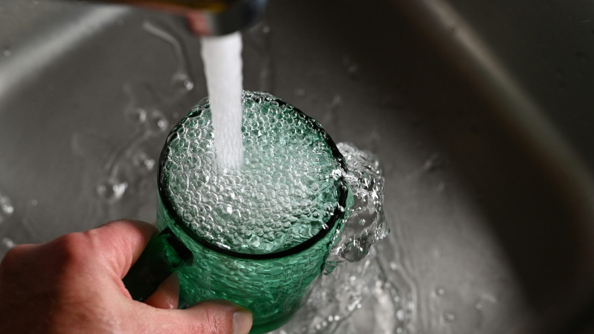 Glass container with water sample for PFAS contamination testing