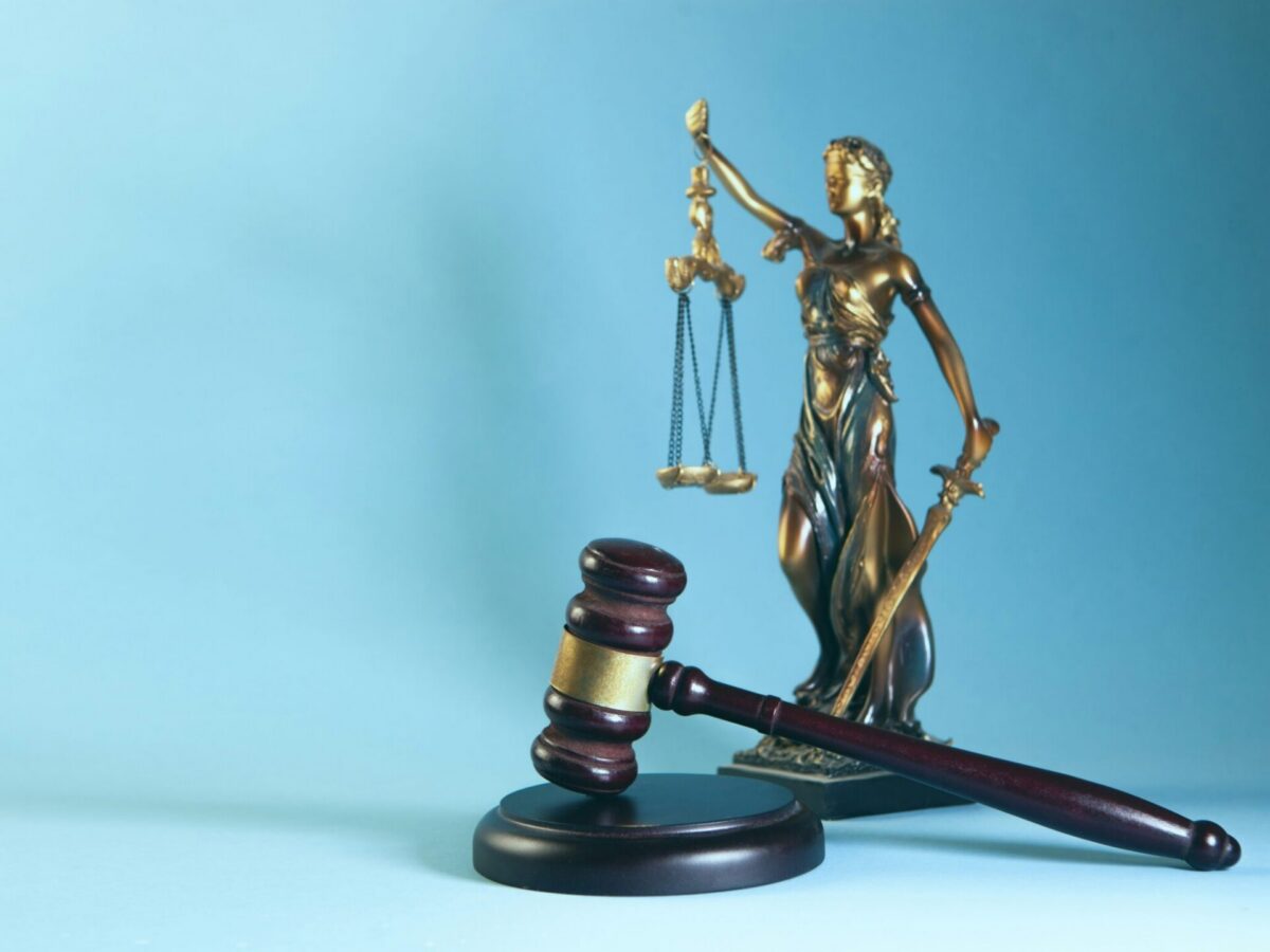 Lady Justice statue and gavel representing the federal lawsuit over voter data in New Jersey.