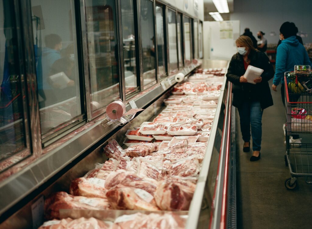 Rows of beef cuts on display in a grocery store meat section