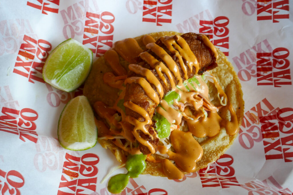 crispy fish taco with cabbage slaw, chipotle aioli, and lime