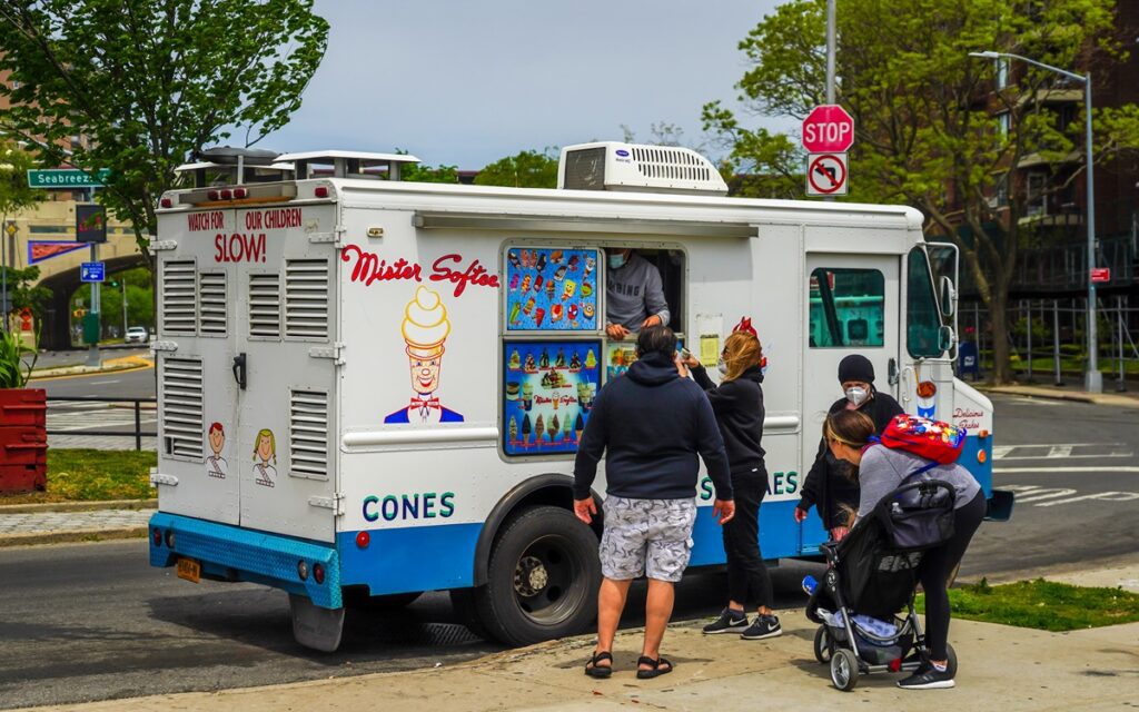 Customers ordering ice cream from a Mister Softee truck, a nostalgic summer staple in New Jersey neighborhoods