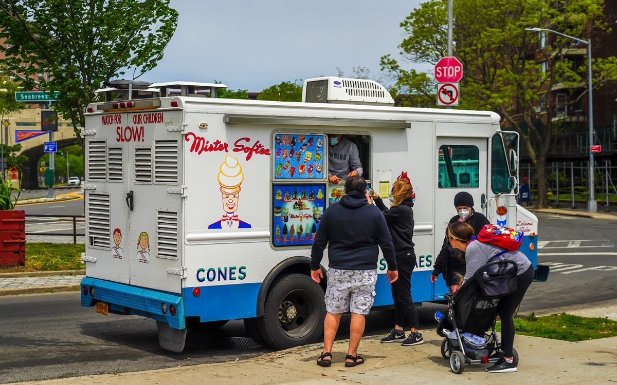 Customers ordering ice cream from a Mister Softee truck, a nostalgic summer staple in New Jersey neighborhoods