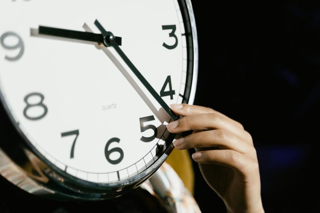 person adjusting clock for NJ daylight saving