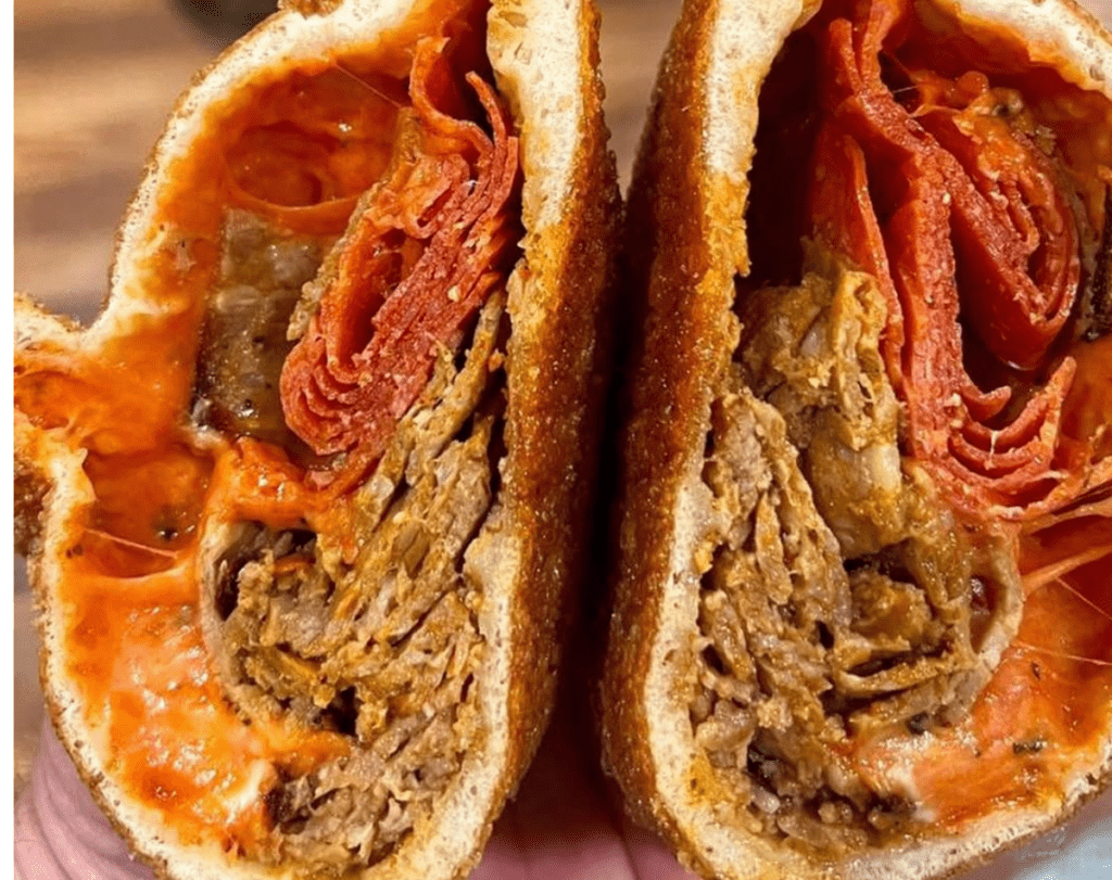 A specialty meat-filled panzarotti from South Jersey split open showing layers of filling