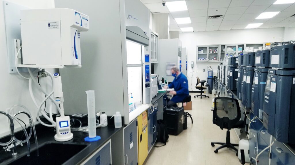 A researcher working inside a pharmaceutical laboratory facility