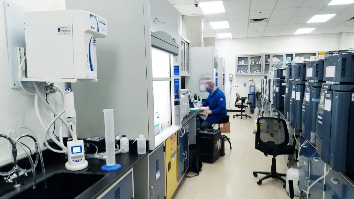 A researcher working inside a pharmaceutical laboratory facility