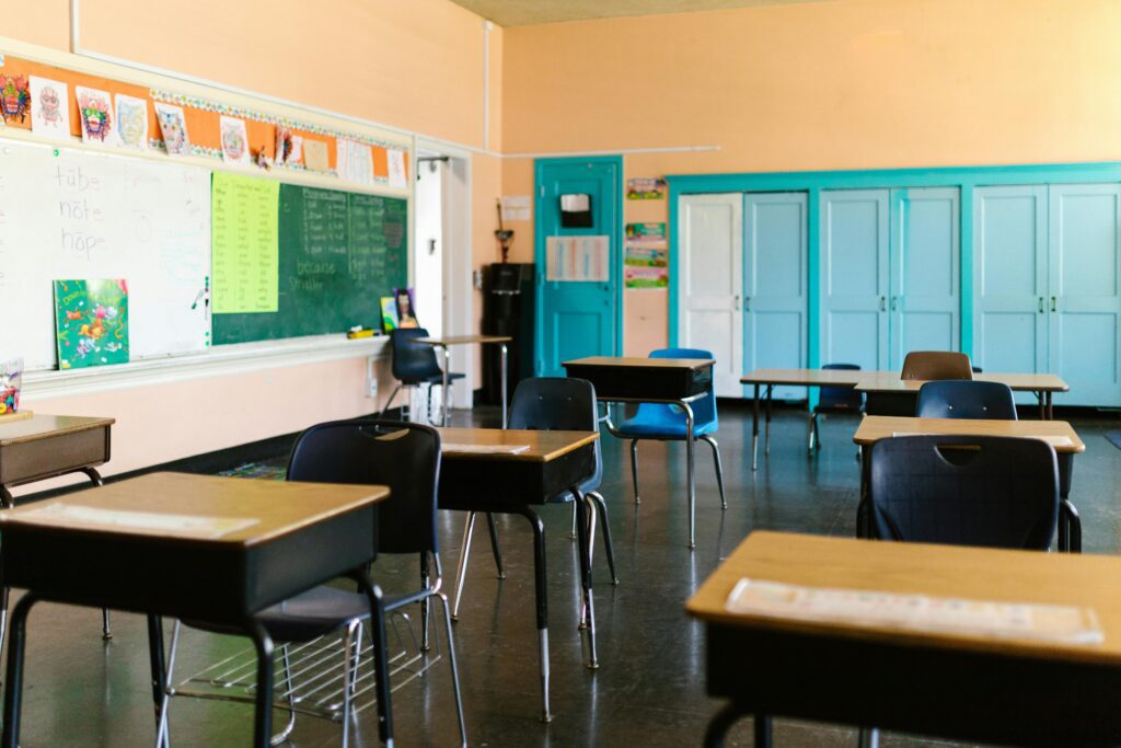 An empty classroom with student desks and a chalkboard in a New Jersey public school