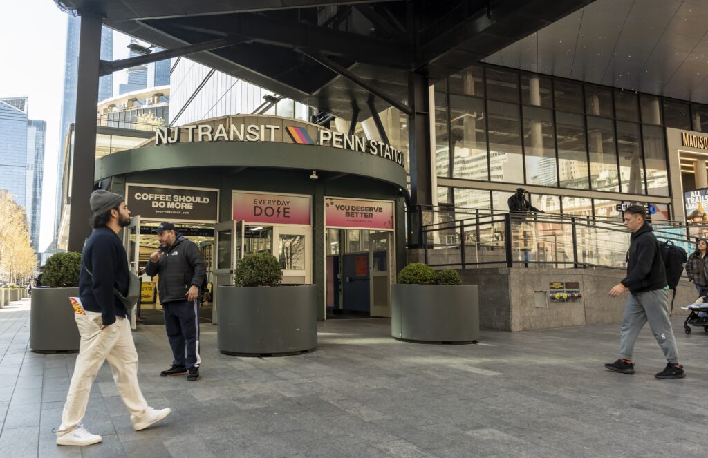 NJ Transit Penn Station entrance in New York City with commuters walking past