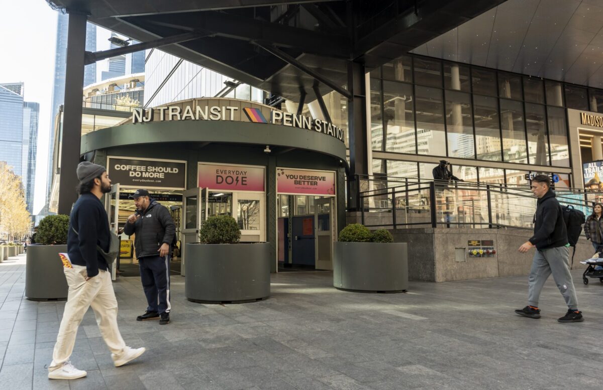 NJ Transit Penn Station entrance in New York City with commuters walking past