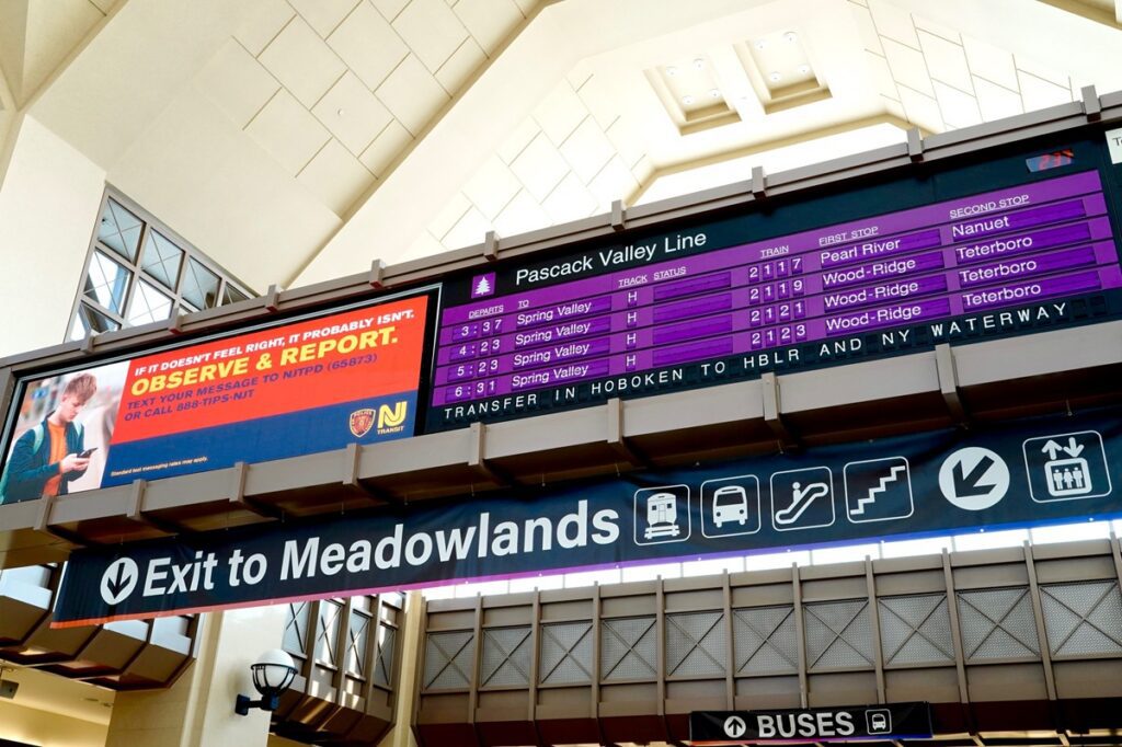 NJ Transit departure board and Exit to Meadowlands sign at Secaucus Junction station in New Jersey