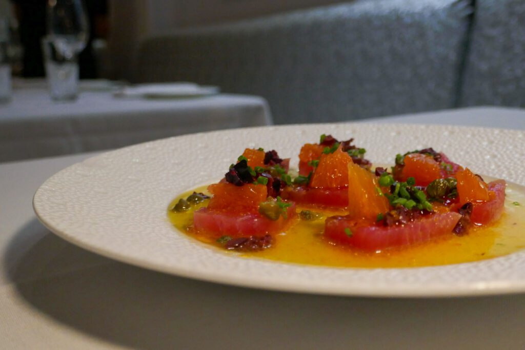 tuna crudo with olive oil, orange, olives, capers