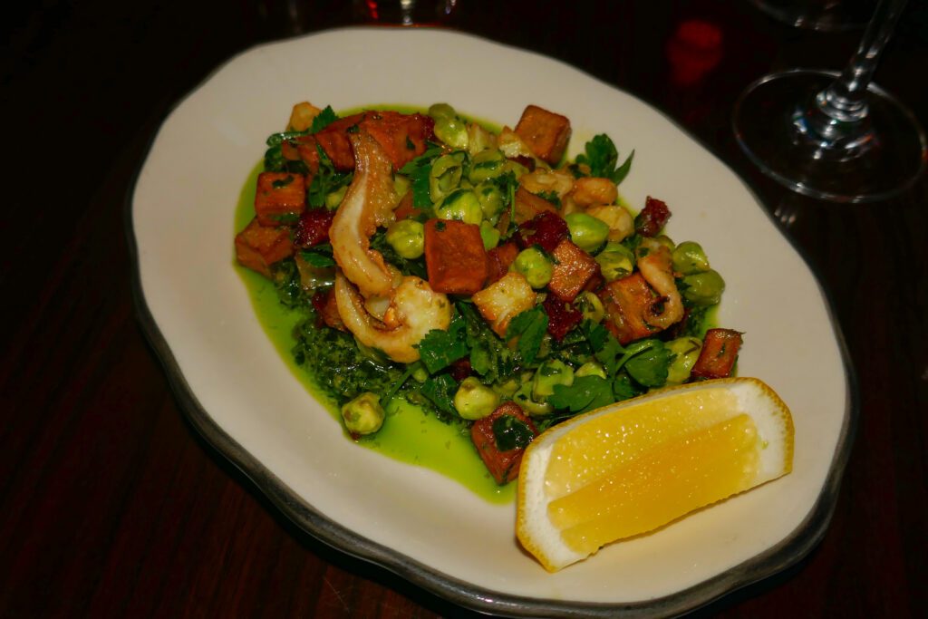 warm squid salad with bright green herbs and chickpeas, cured pork, potatoes