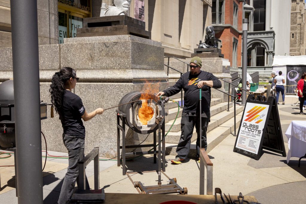 Glass Roots Newark demonstrating glassblowing outside the Newark Museum of Art at STEAM Around the Square