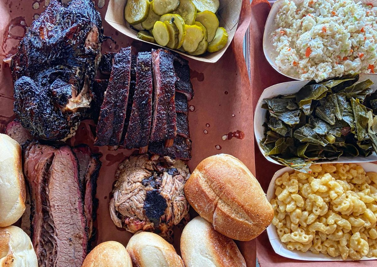A barbecue spread featuring brisket, ribs, pulled pork, mac and cheese, and collard greens at a New Jersey barbecue restaurant