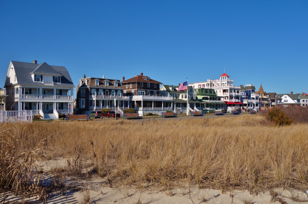 Victorian homes in Cape May New Jersey in front of a dune looking over the beach