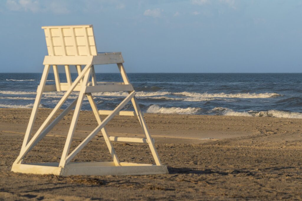 A lifeguard chair on Stone Harbor Beach in New Jersey at sunset with clean sand and clear water