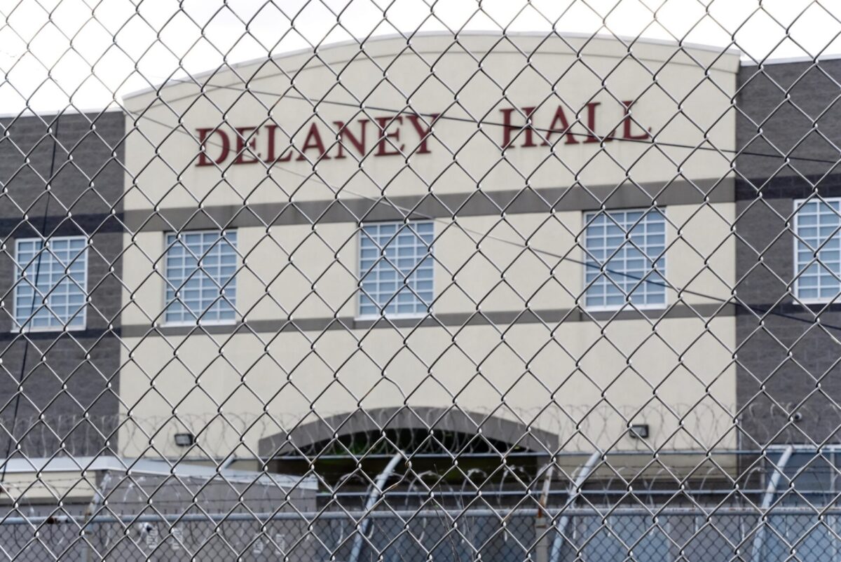 Delaney Hall ICE detention facility in Newark, New Jersey, seen through a chain-link fence