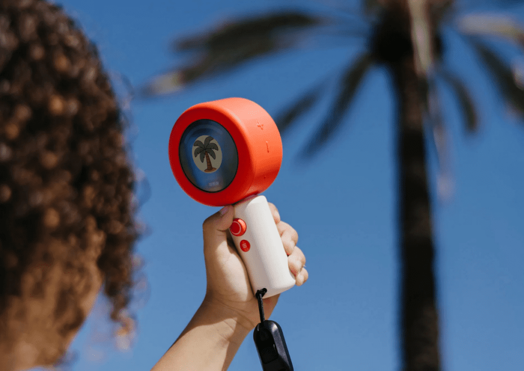 A child using the Dex Camera language learning device to identify objects outdoors