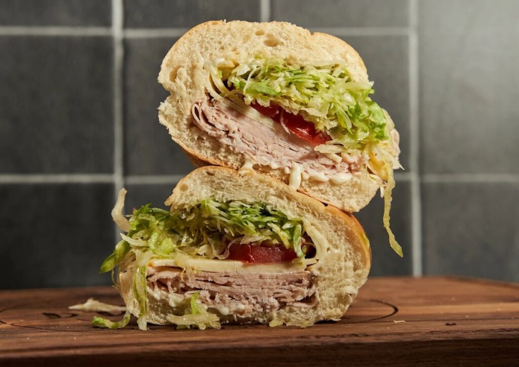 A turkey sub with lettuce, tomato, cheese, and more