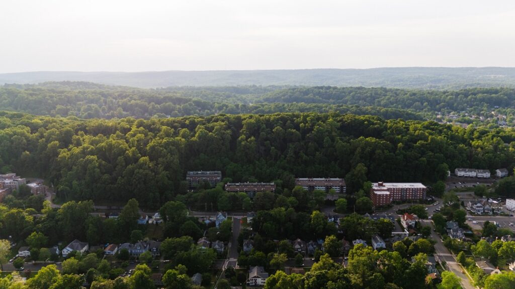 Aerial view of a New Jersey suburban neighborhood surrounded by trees, representing a school district that approved a $31.8 million budget for 2026-27