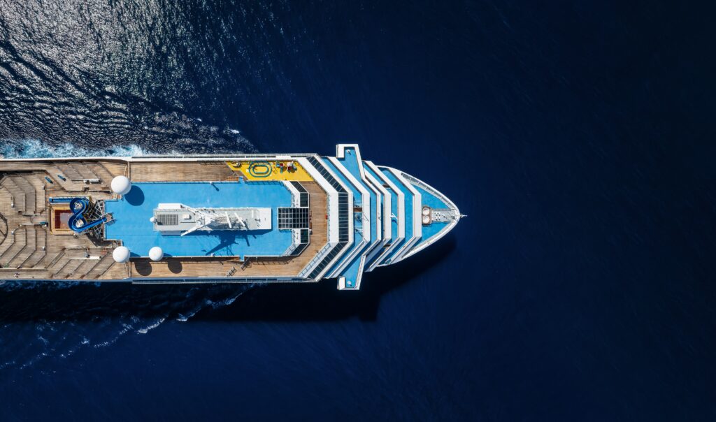 Aerial view of a cruise ship traveling over the ocean, representing the MV Hondius hantavirus outbreak