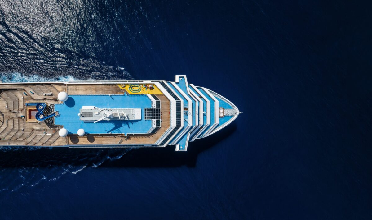 Aerial view of a cruise ship traveling over the ocean, representing the MV Hondius hantavirus outbreak