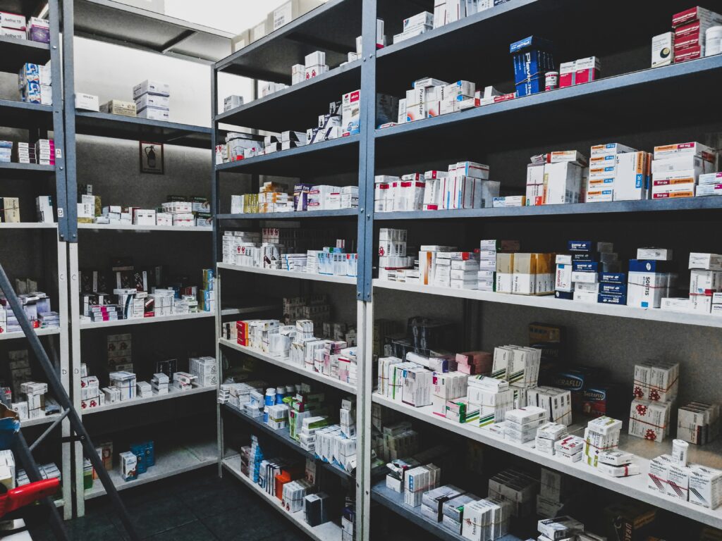 helves stocked with prescription medication boxes at a pharmacy